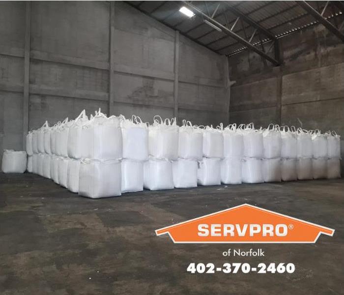 Stacks of fertilizer bags are shown. 